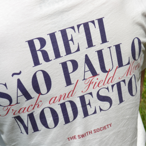 Closeup of the back of swith apres run club crewneck tee with text graphics