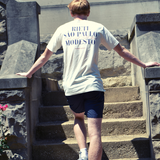 Athlete wearing apres run club crewneck tee with text on the back, walking up stone steps and wearing swith riviera collection shorts.