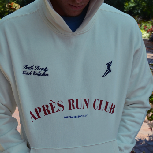 Athletic man wearing swith apres run club relaxed crewneck cream hoodie with the hood up