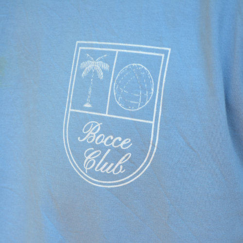 Closeup of Swith bocce club crewneck tee crest with palm tree and bocce call