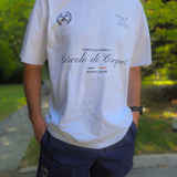 athlete wearing swith croquet club heavy crewneck tee in faded white standing in a garden setting