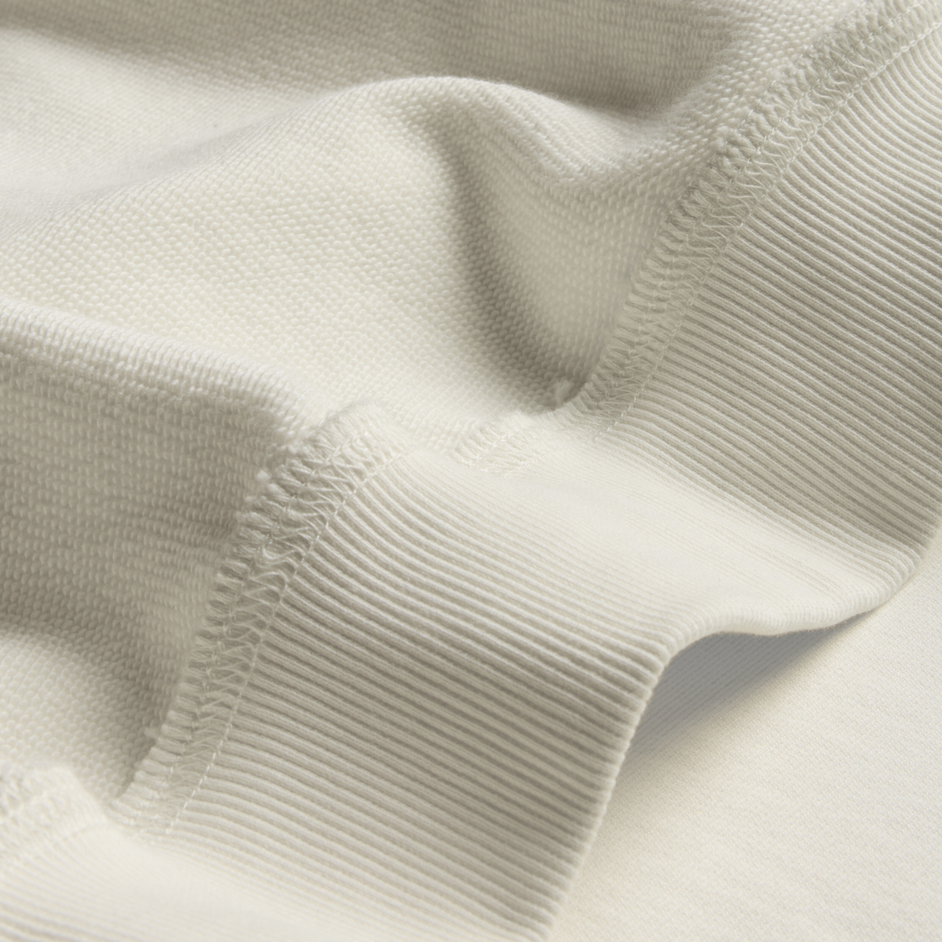Close-up of ribbed knit fabric in natural color and cotton French Terry interior fabric