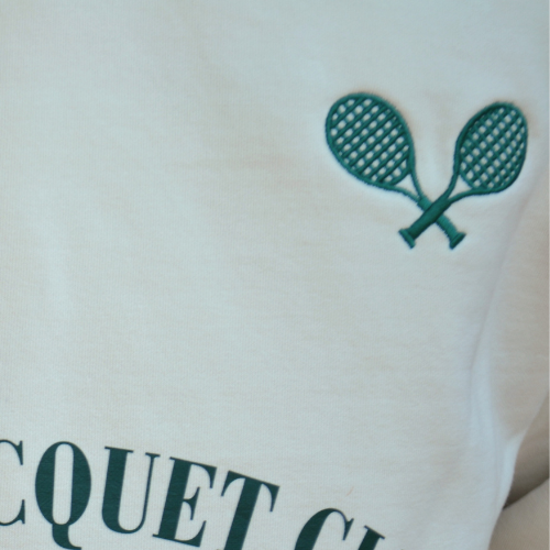 Closeup of Swith apres racquet club relaxed hoodie embroidered racquet detail