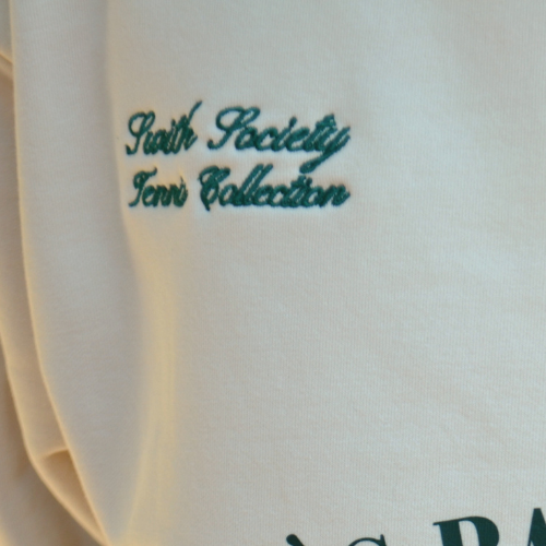 Closeup of swith apres racquet club relaxed hoodie swith society tennis collection embroidery detail